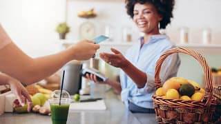 Cashier at cafe running credit card iqMfc.width .jpg