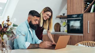 Couple looking up something together on lapto.width oTmPZpv.jpg