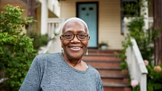 getty smiling happy by porch house.jpg