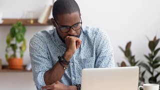 person feeling worried looking at a laptop.jpg