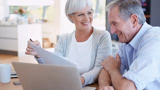 senior couple smiling laptop gettyimages .jpg