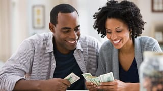 smiling couple counting money.jpg