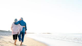 two older people walking on the beach.jpg