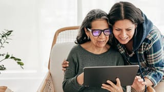 two people looking at a tablet and smiling.jpg