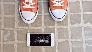 Broken cell phone on ground.width .jpg