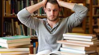 Male college student stressed books library S.width .jpg