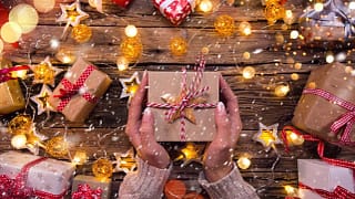 Woman holding wrapped gift YvsdKw.width .jpg