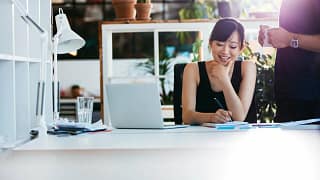 Woman working in office CmcykUG.width .jpg