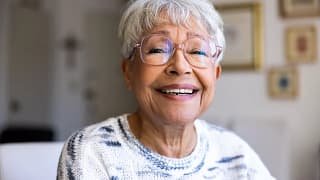 getty happy smiling in light colored top.jpg