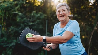 getty happy smiling pickleball player exercise fitness sports.jpg