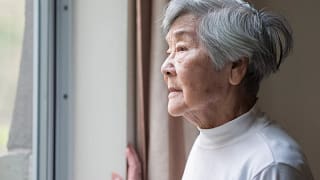 getty looking out window concerned worried older thoughtful.jpg