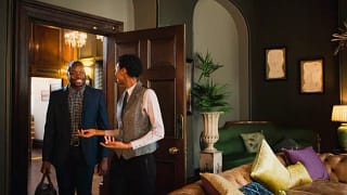 hotel employee showing guest into room miEihM.width .jpg