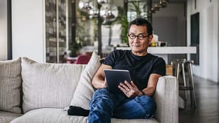 man on couch with tablet FFkBeEk.width .jpg