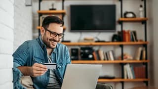 man with credit card and laptop.width .jpg