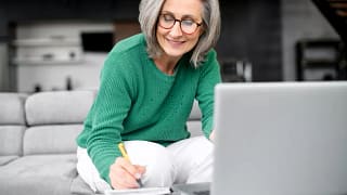 older adult in living room reviewing finances.jpg