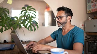 person using a laptop at home.jpg