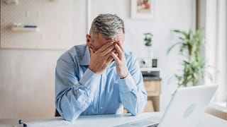 senior man laptop covering face gettyimages .jpg