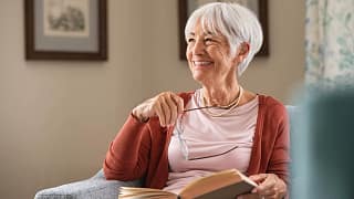 senior woman smiling book gettyimages .jpg