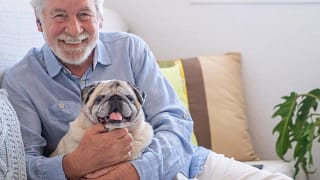 smiling person holding dog gettyimages .jpg