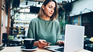 woman in cafe with laptop and credit card.width .jpg