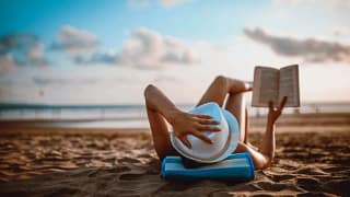 woman reading on beach TUtTQeI.width .jpg