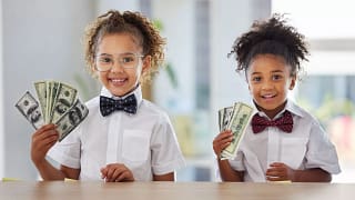 kids holding american currency.jpg