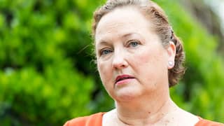 getty person looking concerned thoughtful worried green background.jpg