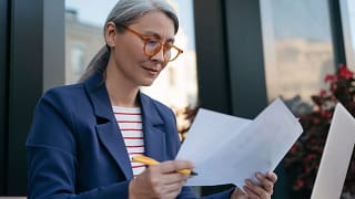 mature businessperson reading documents.jpg