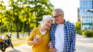 smiling couple walking down street together.jpg