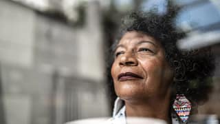 smiling person looking out window.jpg