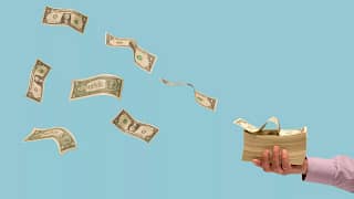 dollar bills flying off a stack of money.jpg