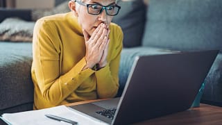 mature woman looking at computer in shock.jpg