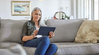 older woman couch tablet gettyimages .jpg