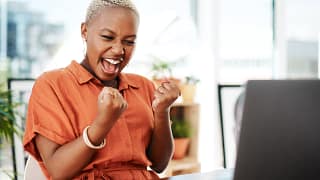 person celebrating victory while looking at computer.jpg