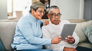 senior couple using a digital tablet at home.jpg