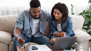smiling couple looking at documents.jpg