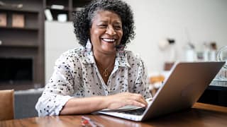 smiling person sitting in front of laptop.jpg