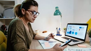 female investor reviewing her portfolio on a laptop.jpg