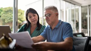 middle aged couple looking at document.jpg