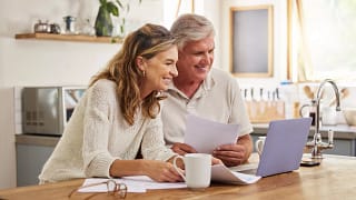 older couple smiling laptop gettyimages .jpg