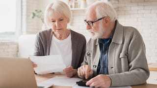 senior couple laptop documents gettyimages .jpg