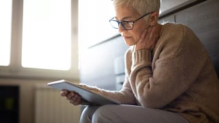 senior woman holding tablet gettyimages .jpg