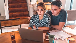 serious couple looking at laptop and discussing finances.jpg