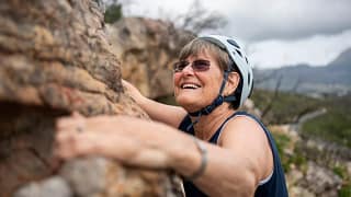 smiling person rock climbing.jpg