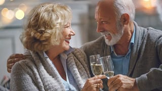 smiling seniors clinking champagne glasses together.jpg