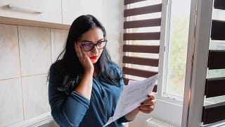 stressed businesswoman reviewing papers.jpg