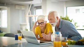 two people with stunned expressions looking at laptop.jpg