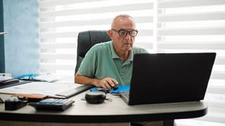 older man desk serious gettyimages .jpg