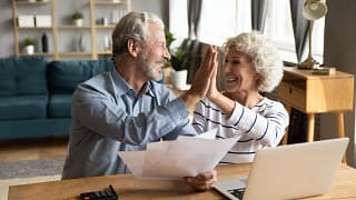 retired couple reviewing finances on a laptop.jpg
