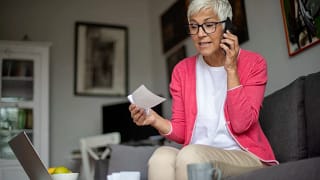 senior holding check and talking on phone.jpg